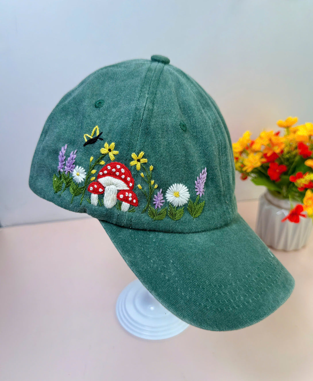 Green Mushroom And Flowers Hand Embroidered Hat by Stitchery Zone with colorful floral and mushroom design