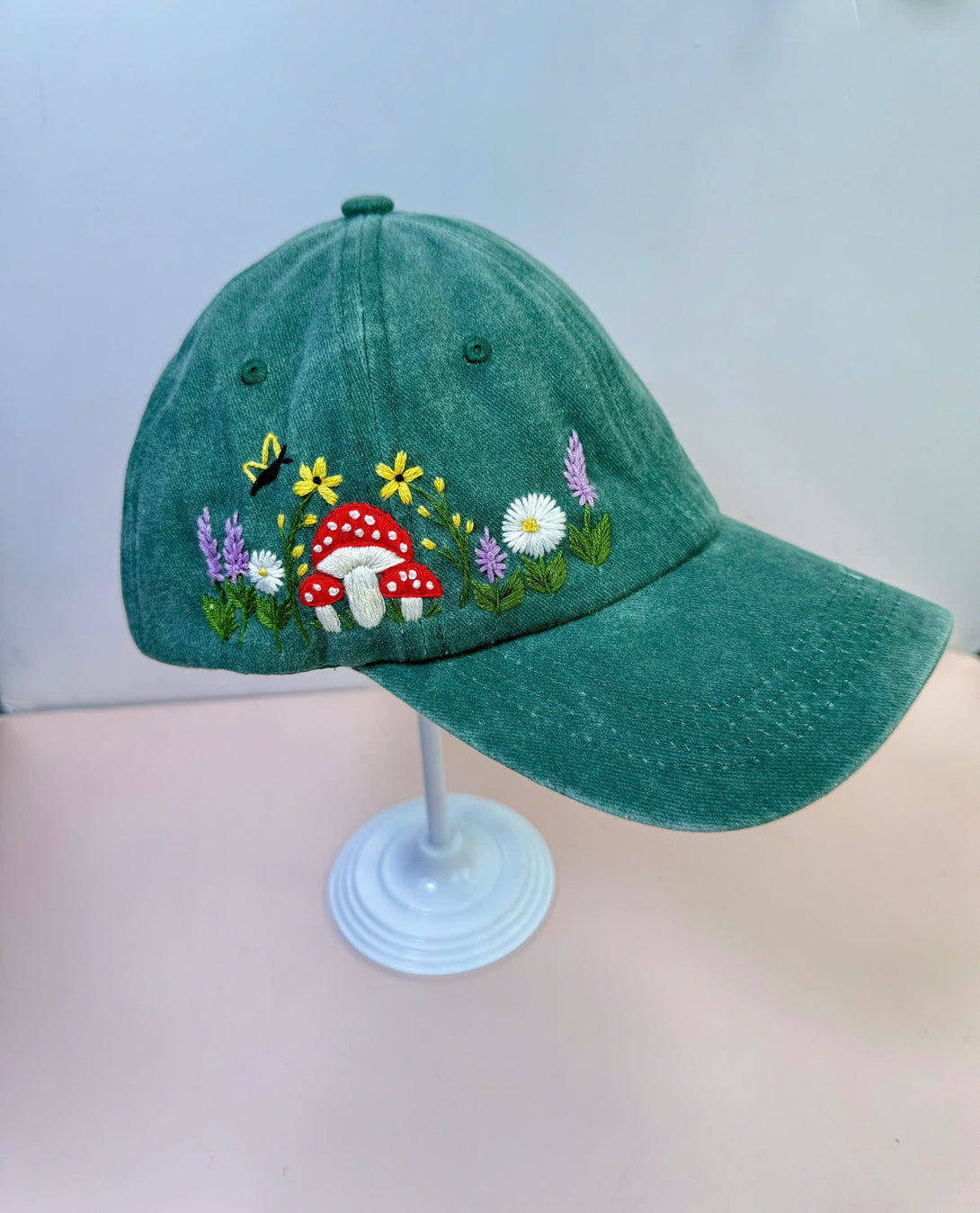 Stitchery Zone Mushroom And Flowers Hand Embroidered Hat in green with colorful floral and mushroom design