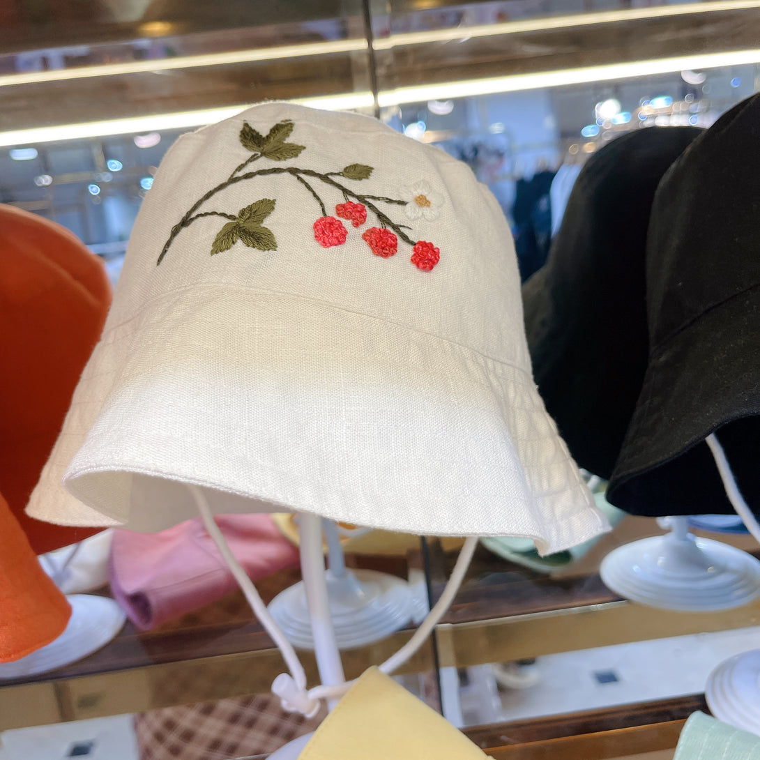 Hand Embroidered Berry Linen Baby Hat in white with red berry embroidery and green leaves by Stitchery Zone