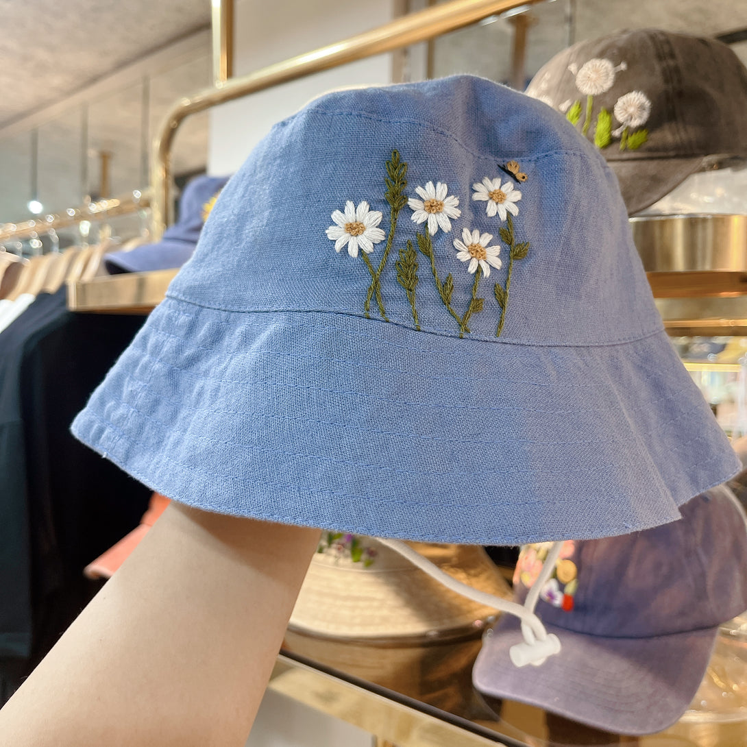 Light blue Hand Embroidered Daisy and Bee Linen Baby Hat with floral and bee design by Stitchery Zone