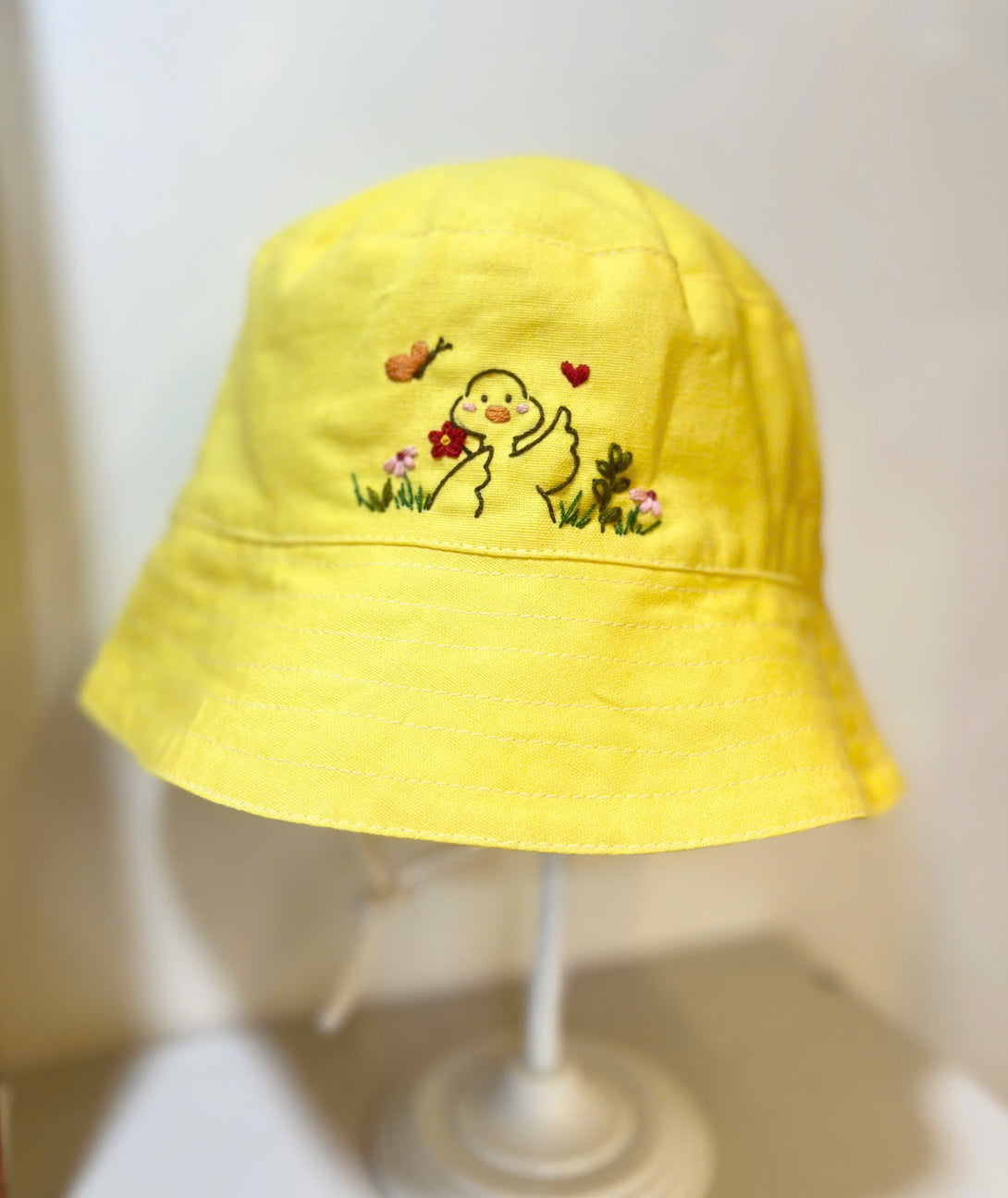 Hand Embroidered Duck Linen Baby Hat in yellow with cute duck and floral embroidery by Stitchery Zone