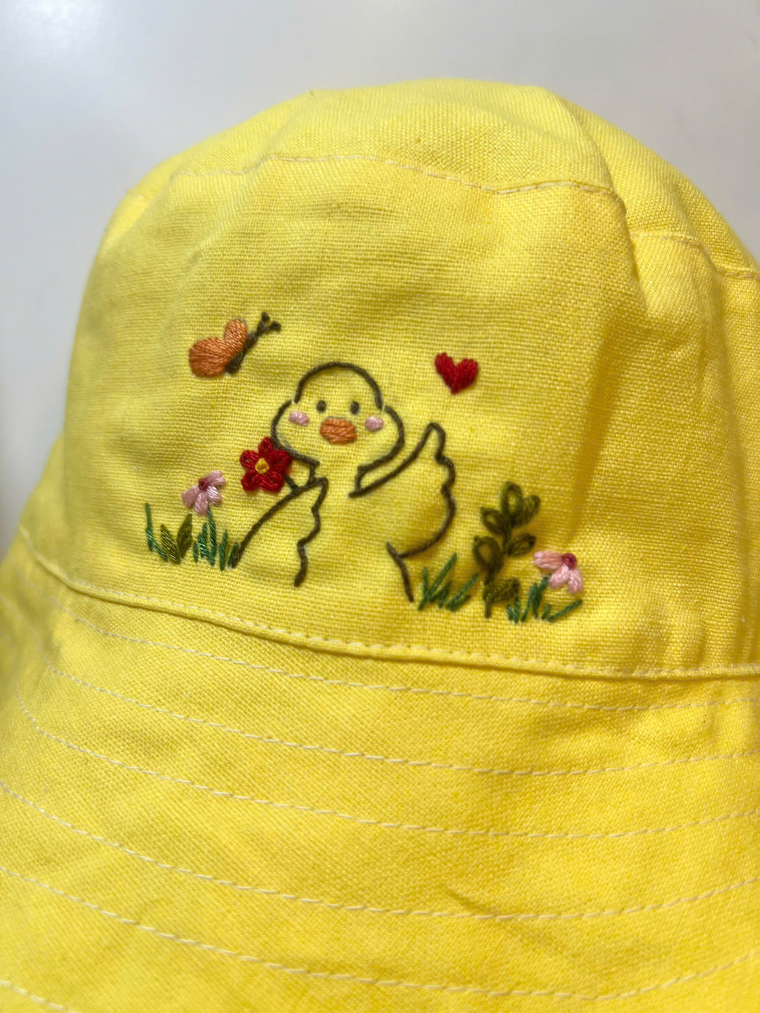 Hand Embroidered Duck Linen Baby Hat in yellow with cute duck, flowers, and butterfly embroidery