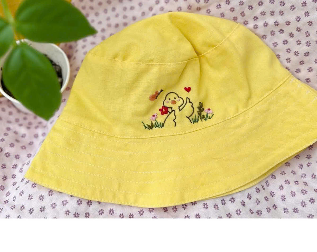 Hand Embroidered Duck Linen Baby Hat in yellow with cute duck and flower embroidery by Stitchery Zone