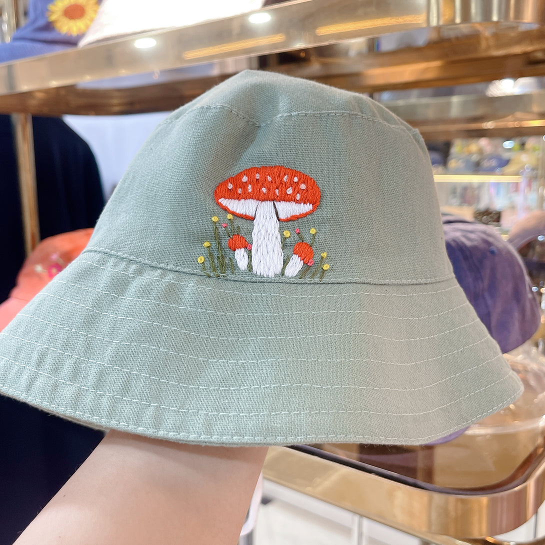 Hand Embroidered Mushroom Linen Baby Hat in light green with red and white mushroom embroidery by Stitchery Zone