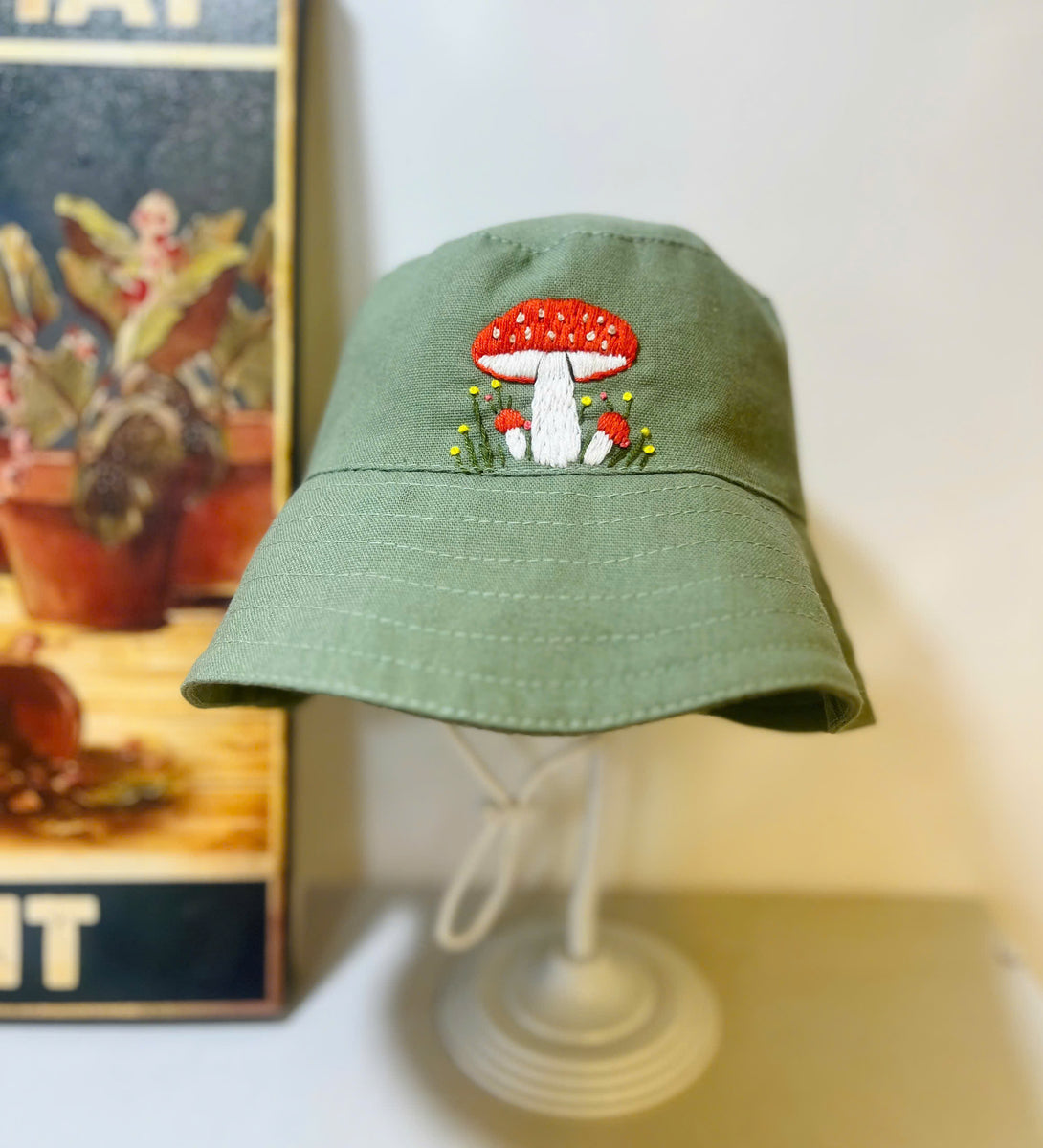 Hand Embroidered Mushroom Linen Baby Hat in green with red and white mushroom embroidery by Stitchery Zone