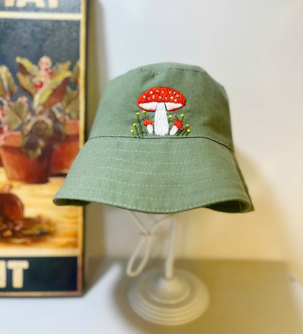 Hand Embroidered Mushroom Linen Baby Hat in green with red and white mushroom embroidery by Stitchery Zone