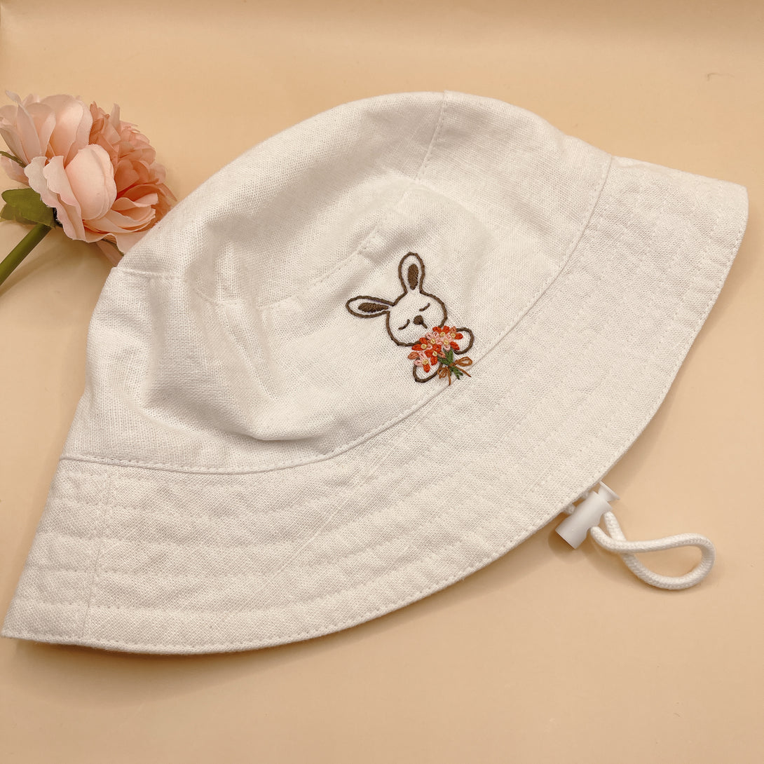 Hand Embroidered Rabbit Linen Baby Hat in white with floral embroidery and adjustable chin strap