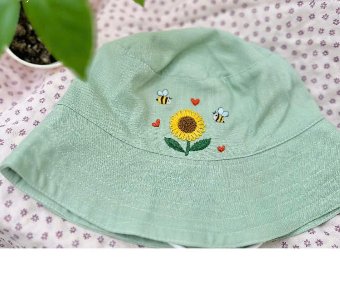Hand Embroidered Sunflower and Bee Linen Baby Hat in light green with detailed embroidery from Stitchery Zone