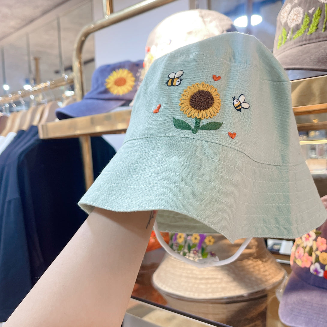 Hand Embroidered Sunflower and Bee Linen Baby Hat in light green with cute floral embroidery