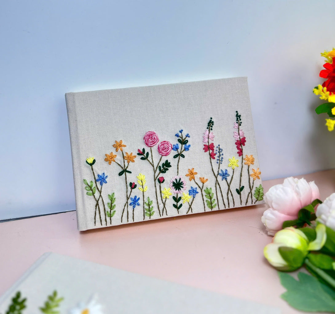 Stitchery Zone Handmade Wedding Guest Book with embroidered colorful wildflowers on linen cover