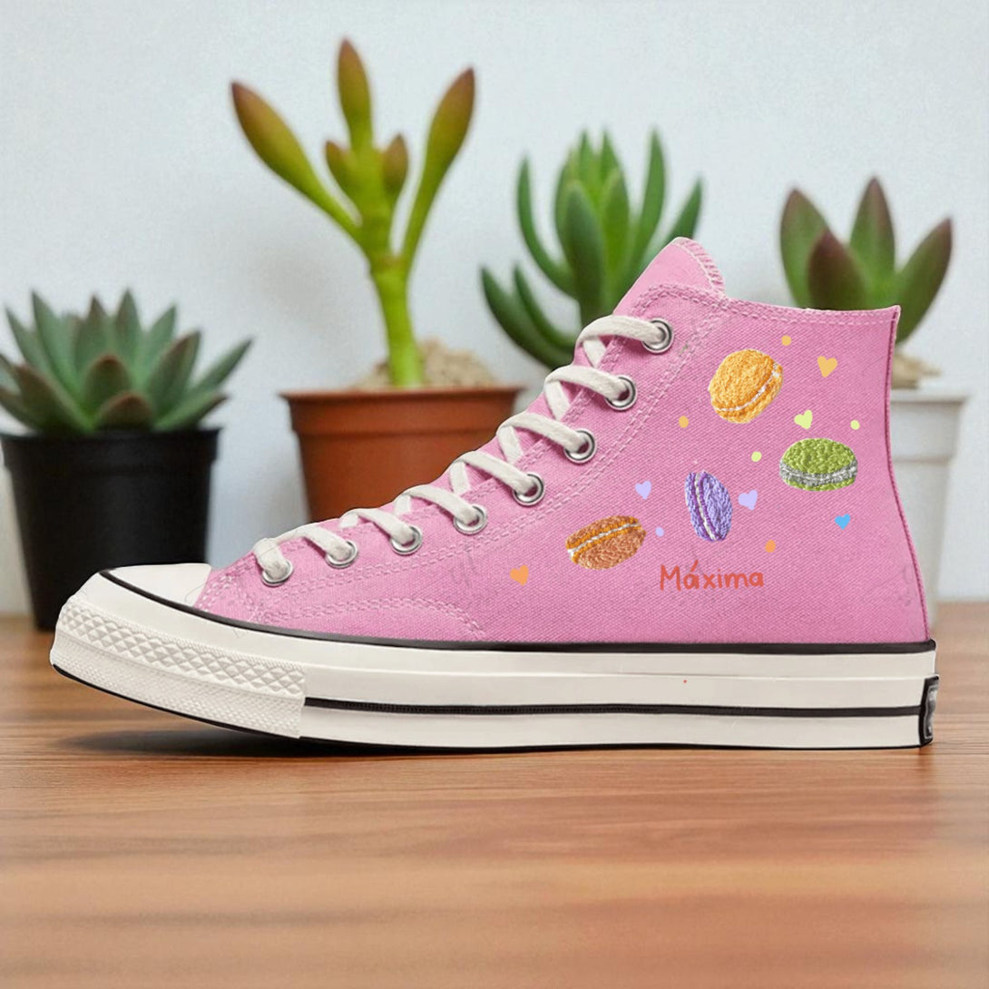 Pink embroidered high top Hello Kitty Converse shoe with colorful macaron motifs and embroidered Maxima name