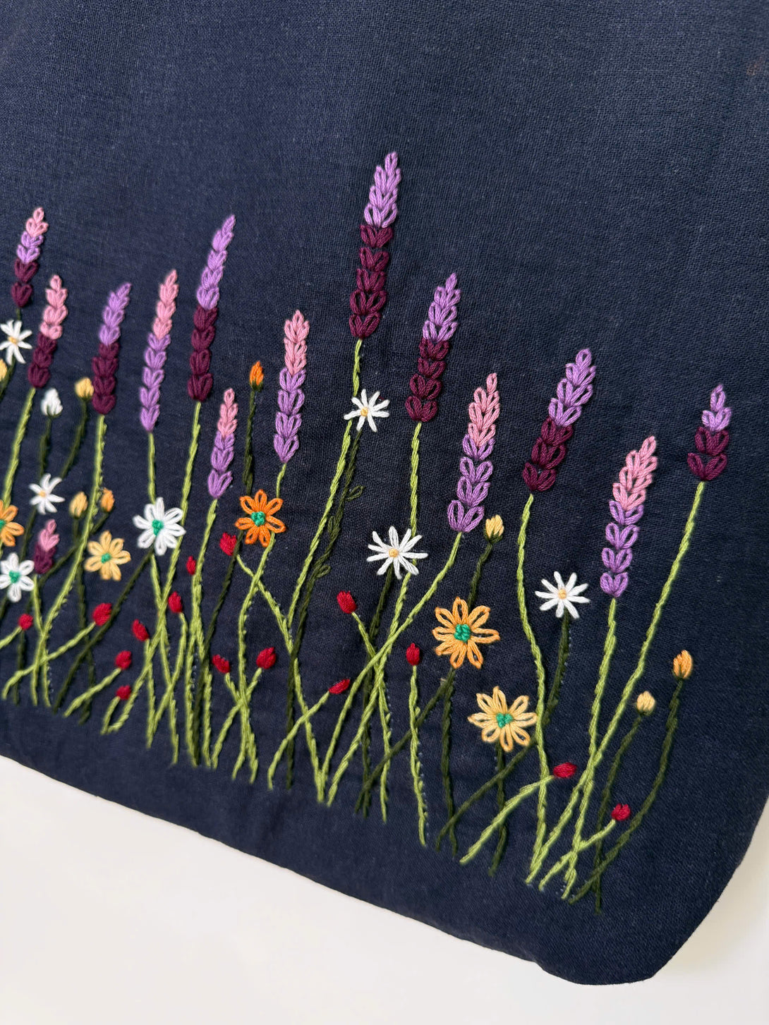 Lavender Garden Hand Embroidered Tote Bag with colorful floral embroidery on dark fabric by Stitchery Zone