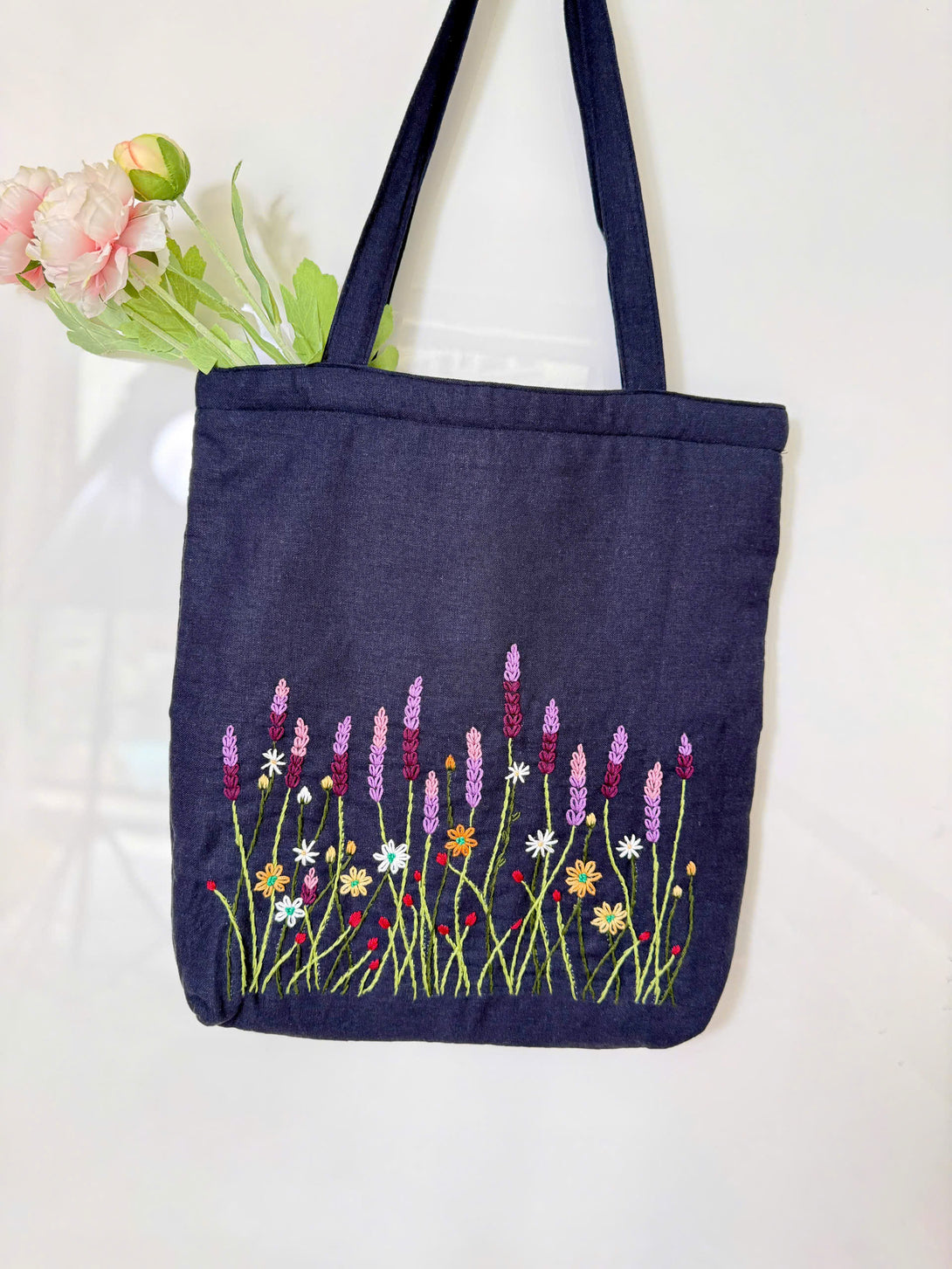 Lavender Garden Hand Embroidered Tote Bag by Stitchery Zone with floral design on navy fabric
