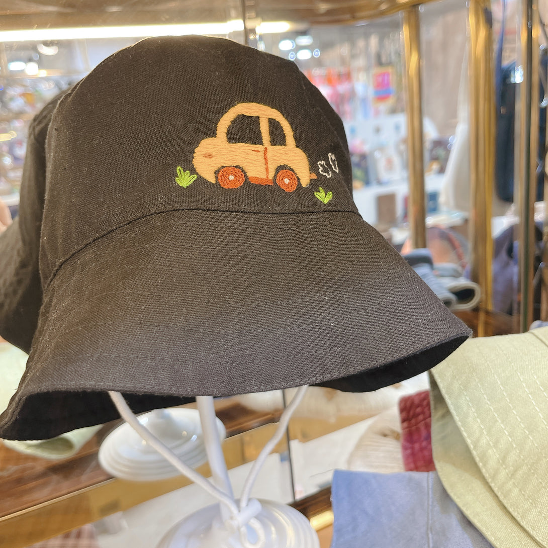 Little Embroidered Linen Baby Hat in black with orange car design by Stitchery Zone