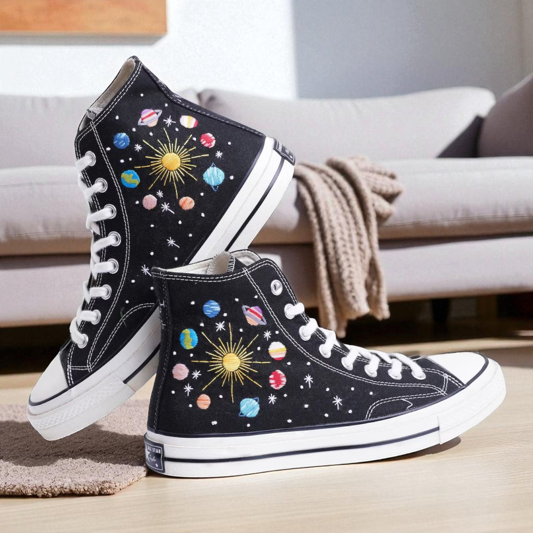 Moon Converse high-top shoes featuring colorful planet embroidery on a black canvas background