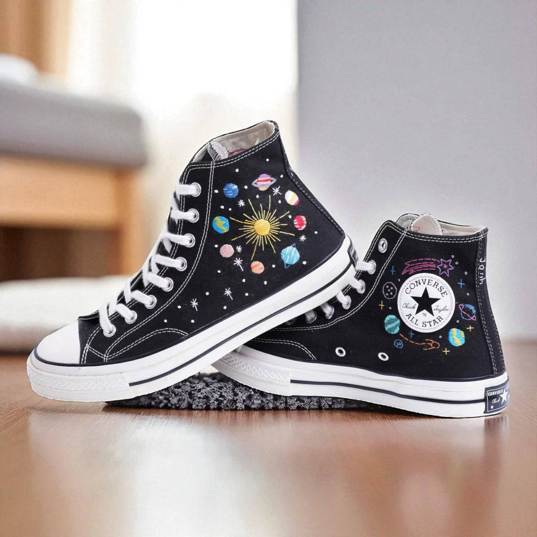 Moon Converse embroidered shoes featuring a space theme with planets and stars on a black background