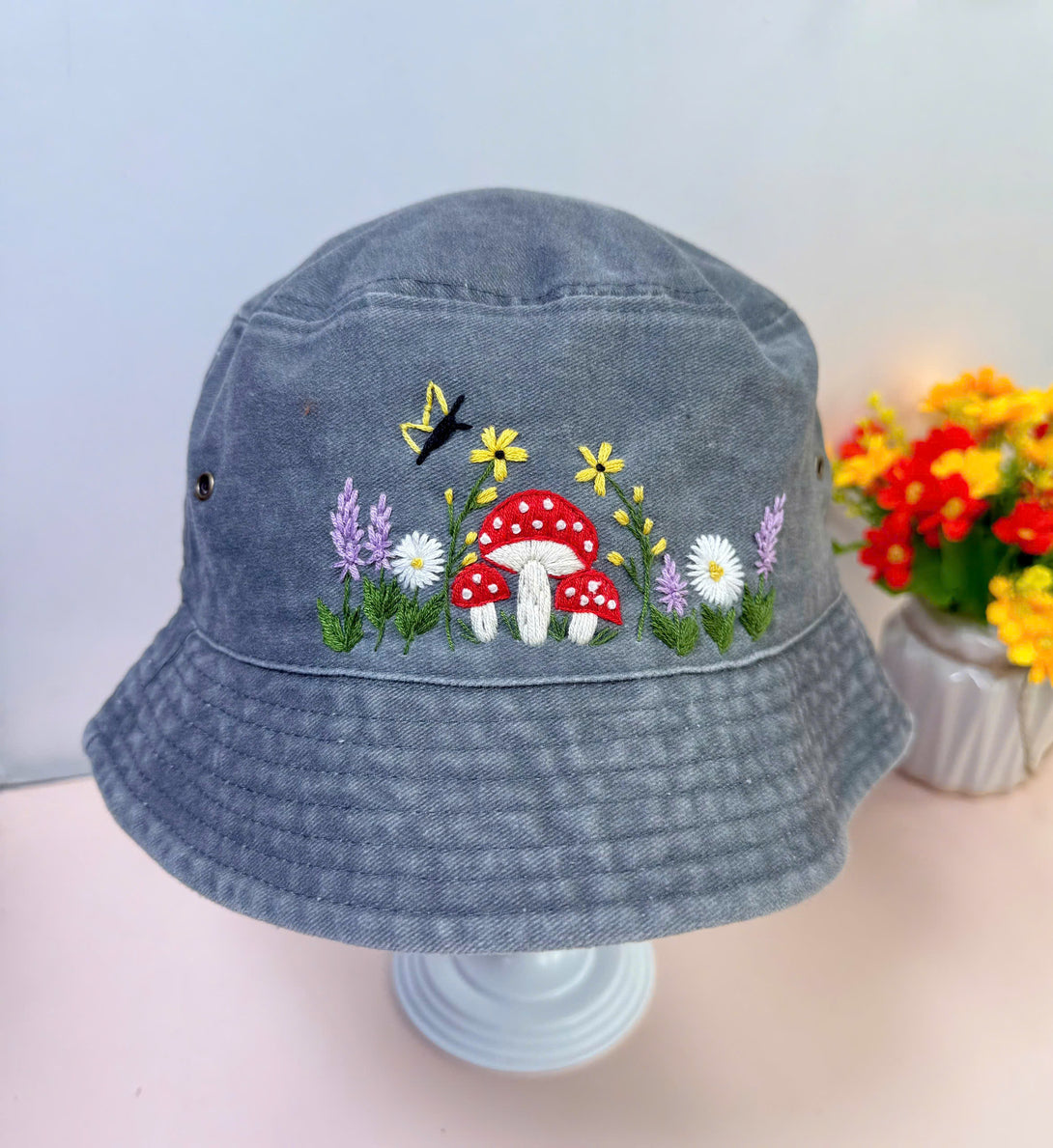 Stitchery Zone Mushroom And Flowers Hand Embroidered Bucket Hat in gray with colorful floral and mushroom design