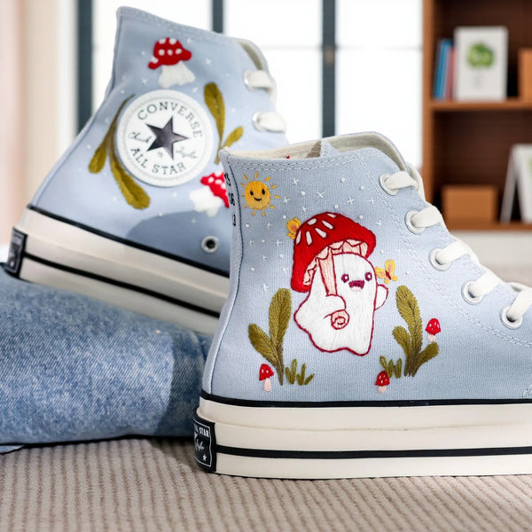 Mushroom Converse high-top shoes with colorful embroidery and playful designs on a light blue background