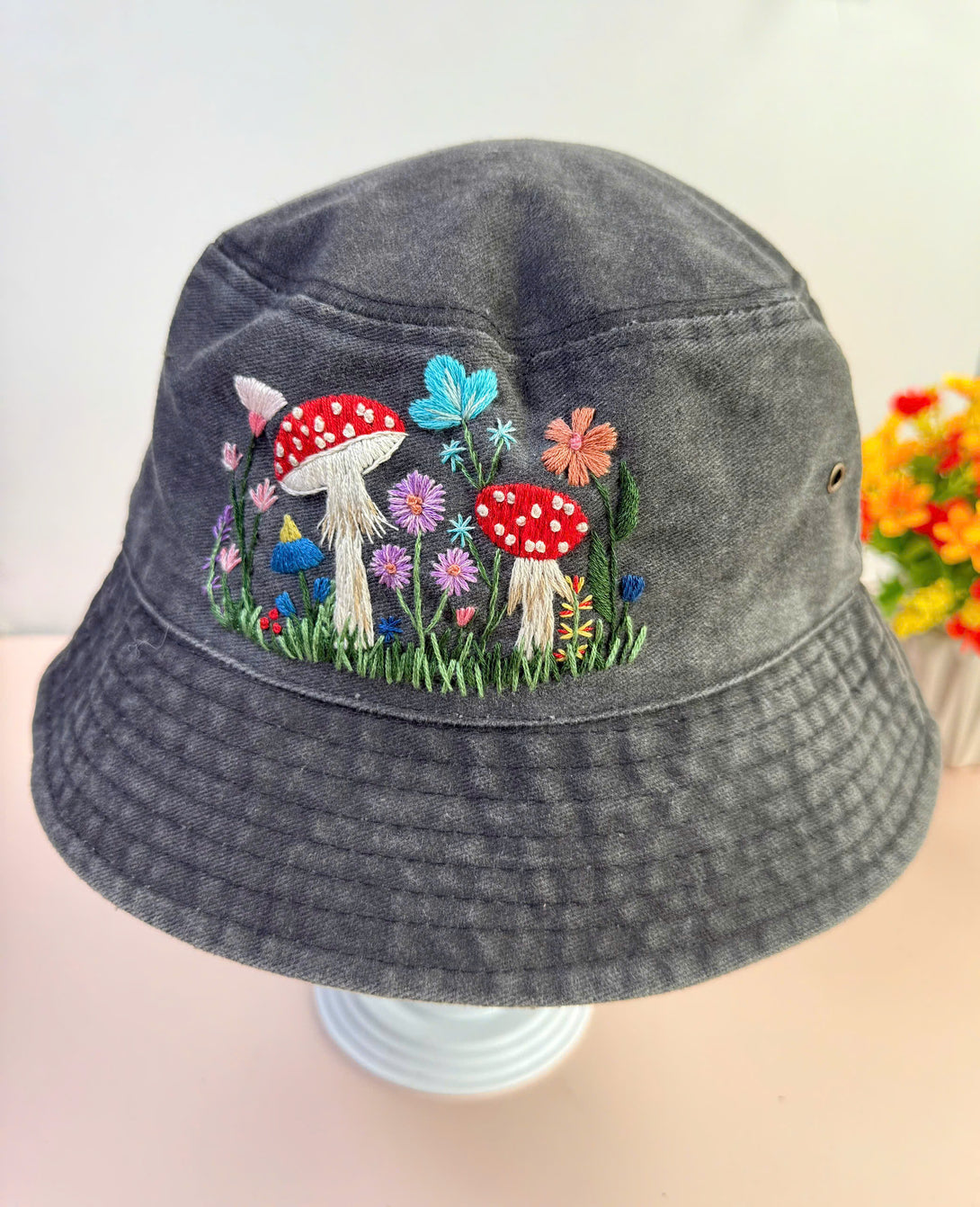 Stitchery Zone Mushroom Hand Embroidered Bucket Hat in gray with colorful floral and mushroom embroidery