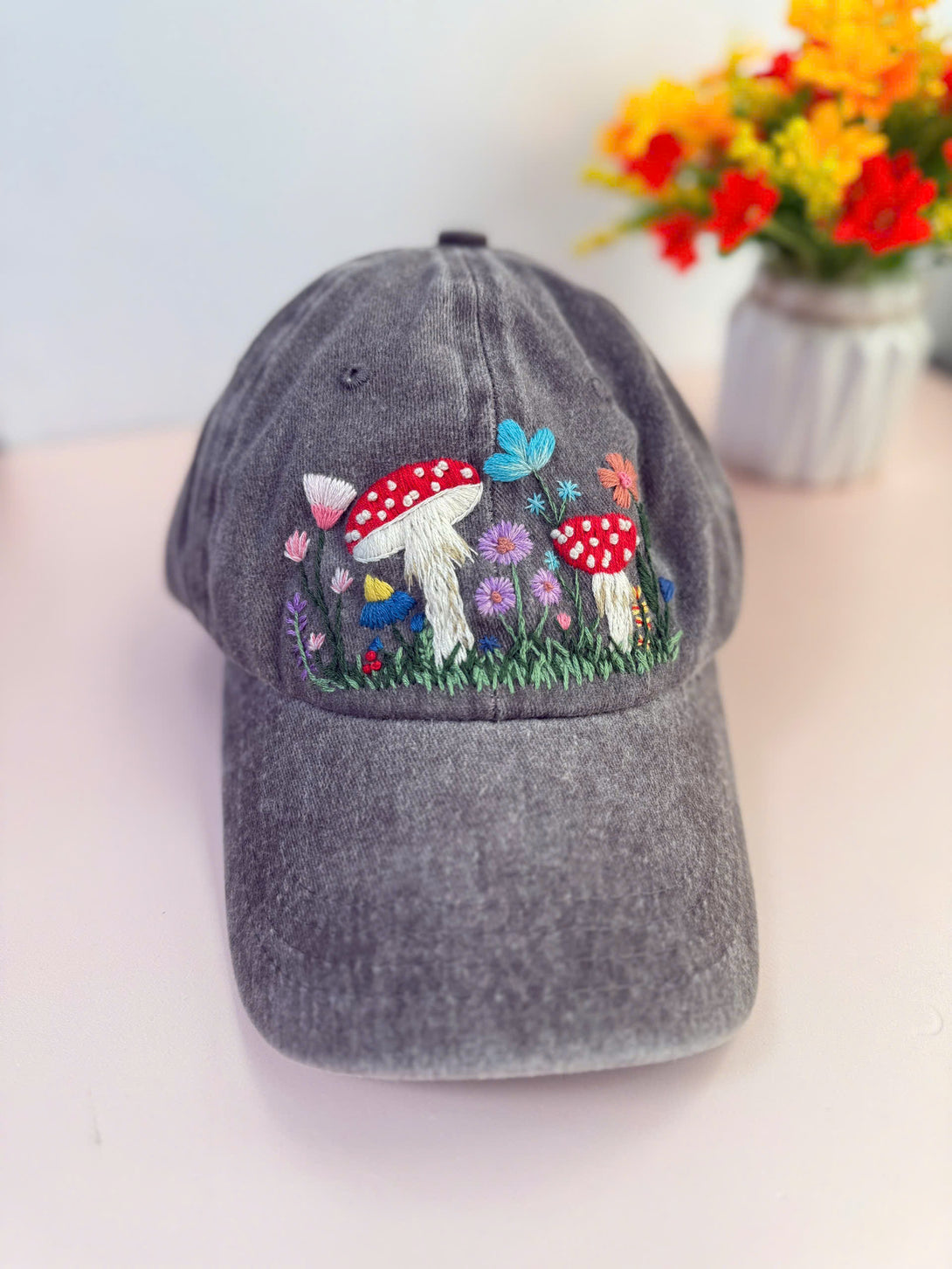 Gray Mushroom Hand Embroidered Hat by Stitchery Zone with colorful mushrooms and flowers embroidery