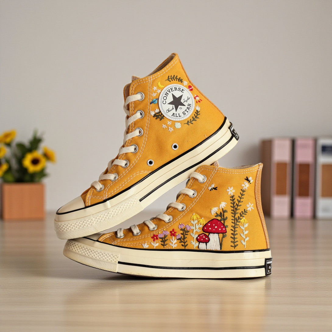 Converse embroidered mushroom shoes for women with colorful floral designs on a yellow background