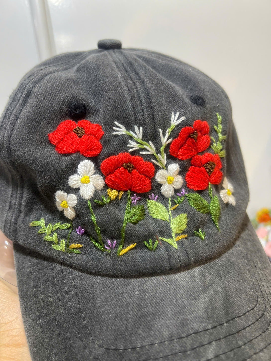 Peonies Hand Embroidered Hat by Stitchery Zone with red and white floral embroidery on black fabric