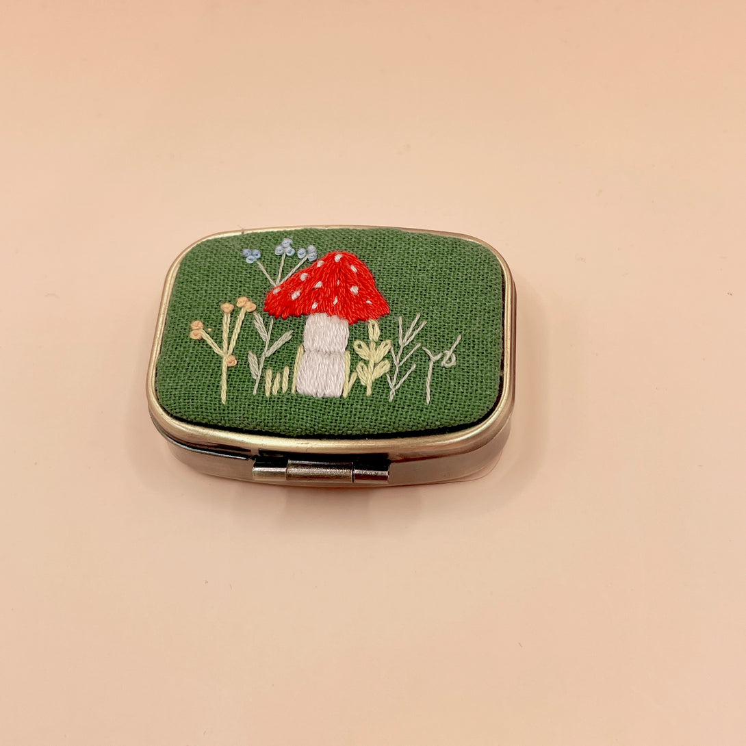 Personalized Embroidered Jewelry Box with green fabric featuring red mushroom and floral embroidery by Stitchery Zone