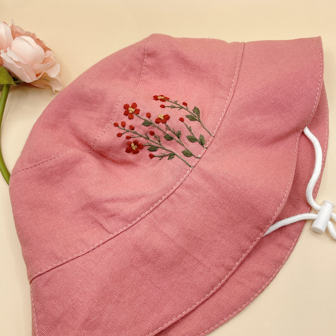 Pink flowers Embroidered Linen Baby Hat by Stitchery Zone with delicate red floral embroidery and adjustable chin strap