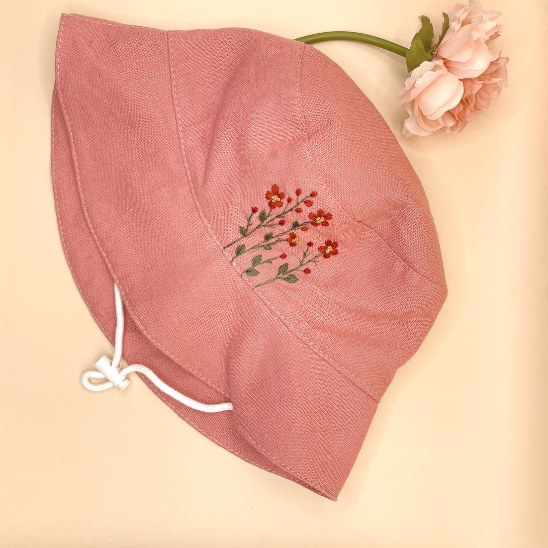 Pink flowers Embroidered Linen Baby Hat by Stitchery Zone with delicate floral design and chin strap