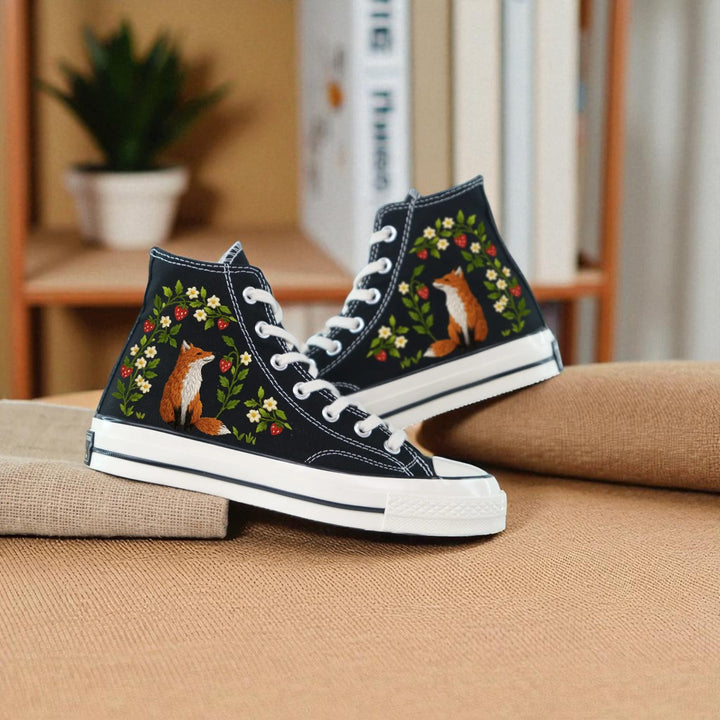Strawberry Converse embroidered shoes with vibrant fox and floral designs on a black background