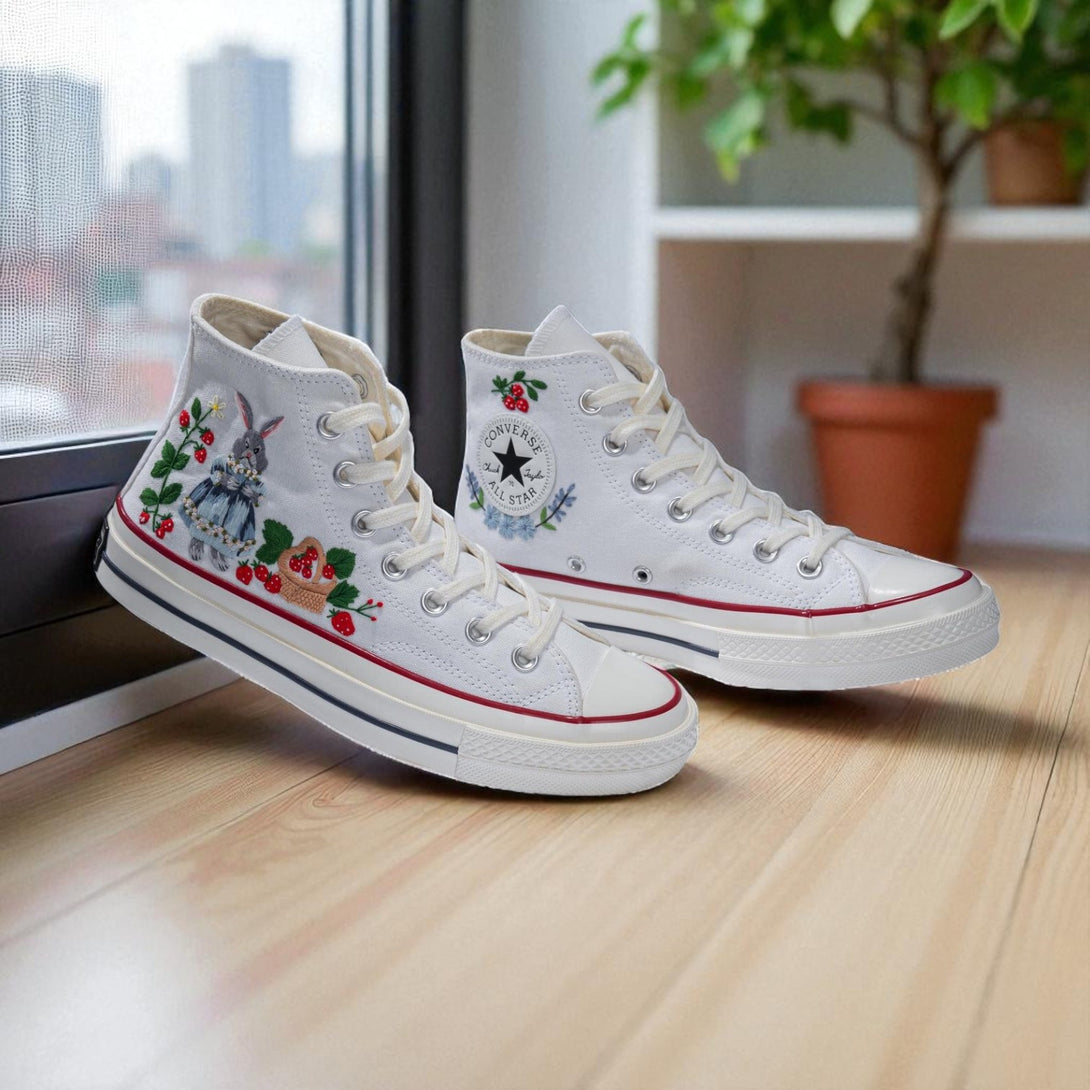 Strawberry Converse high-top shoes featuring colorful floral embroidery and classic design