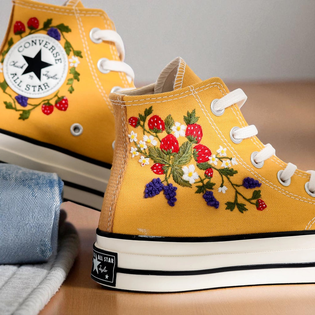 Strawberry Converse high-top shoes with colorful floral embroidery and classic Chuck Taylor design