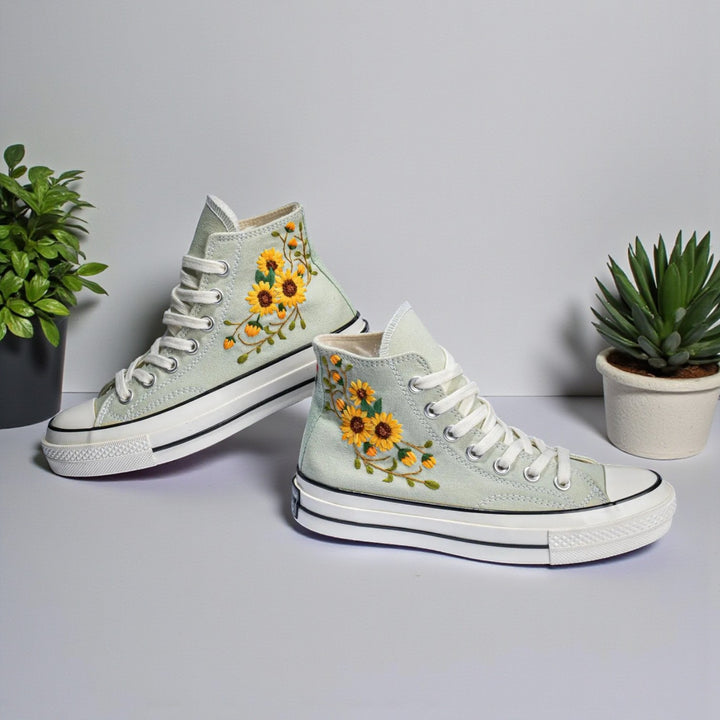 Sunflower Converse high-top shoes featuring vibrant sunflower embroidery on a light green canvas