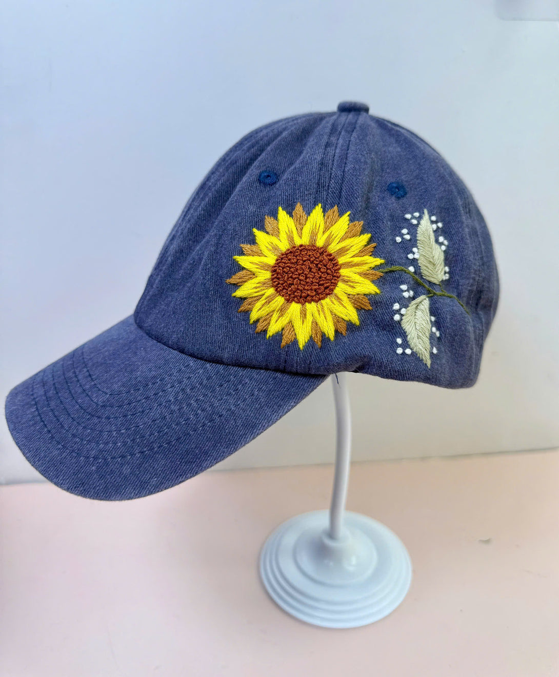 Stitchery Zone Sunflower Embroidered Hat in blue with bright yellow sunflower design and leaf details