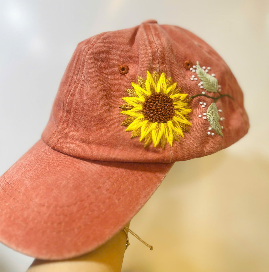 Rust-colored Sunflower Embroidered Hat with yellow sunflower and green leaf details by Stitchery Zone
