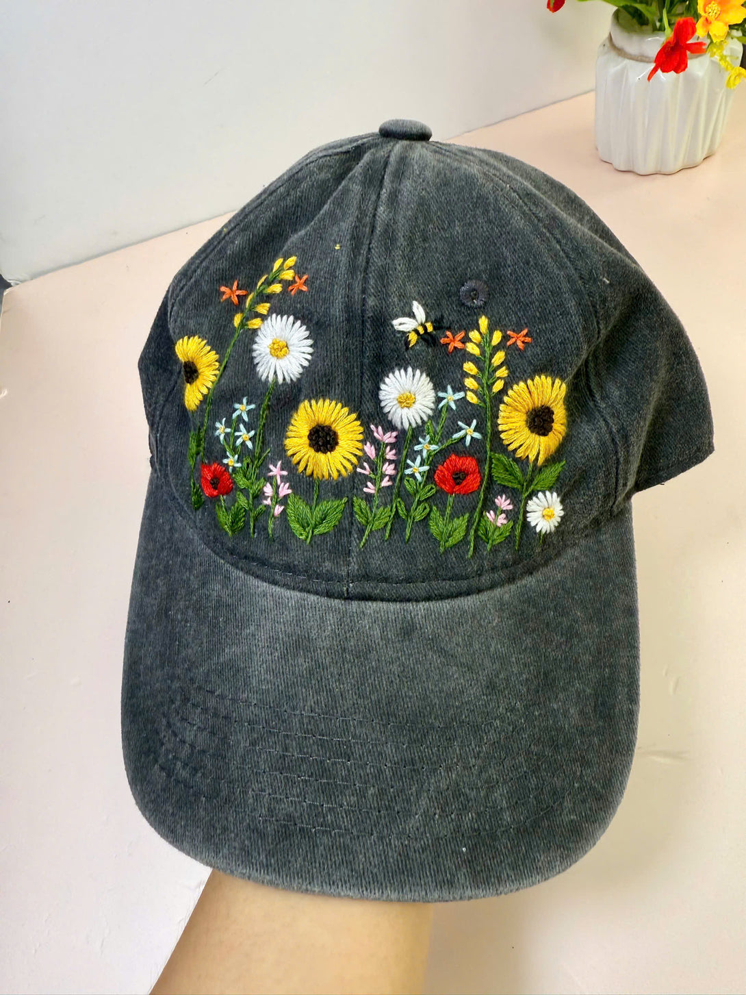 Stitchery Zone Sunflower Hand Embroidered Hat with colorful floral embroidery on black fabric