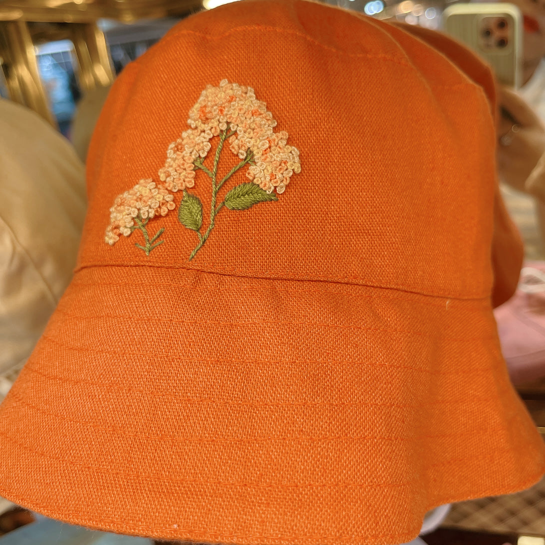 Orange Embroidered Linen Baby Hat by Stitchery Zone featuring delicate floral embroidery on bright orange fabric