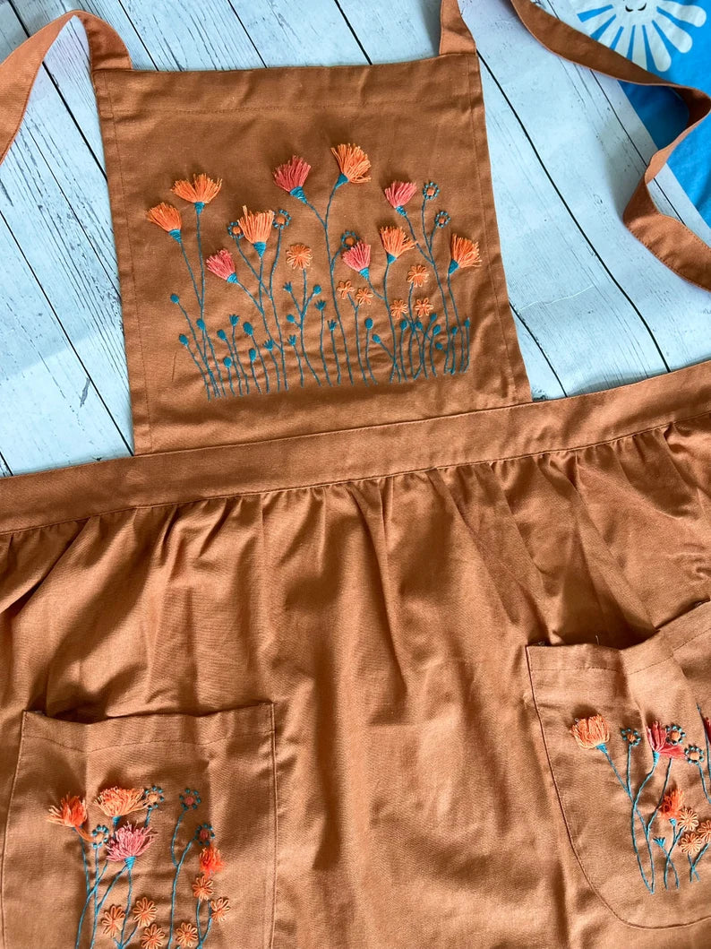 Brown Floral Embroidered Apron For Women with orange and pink flower designs and front pockets by Stitchery Zone