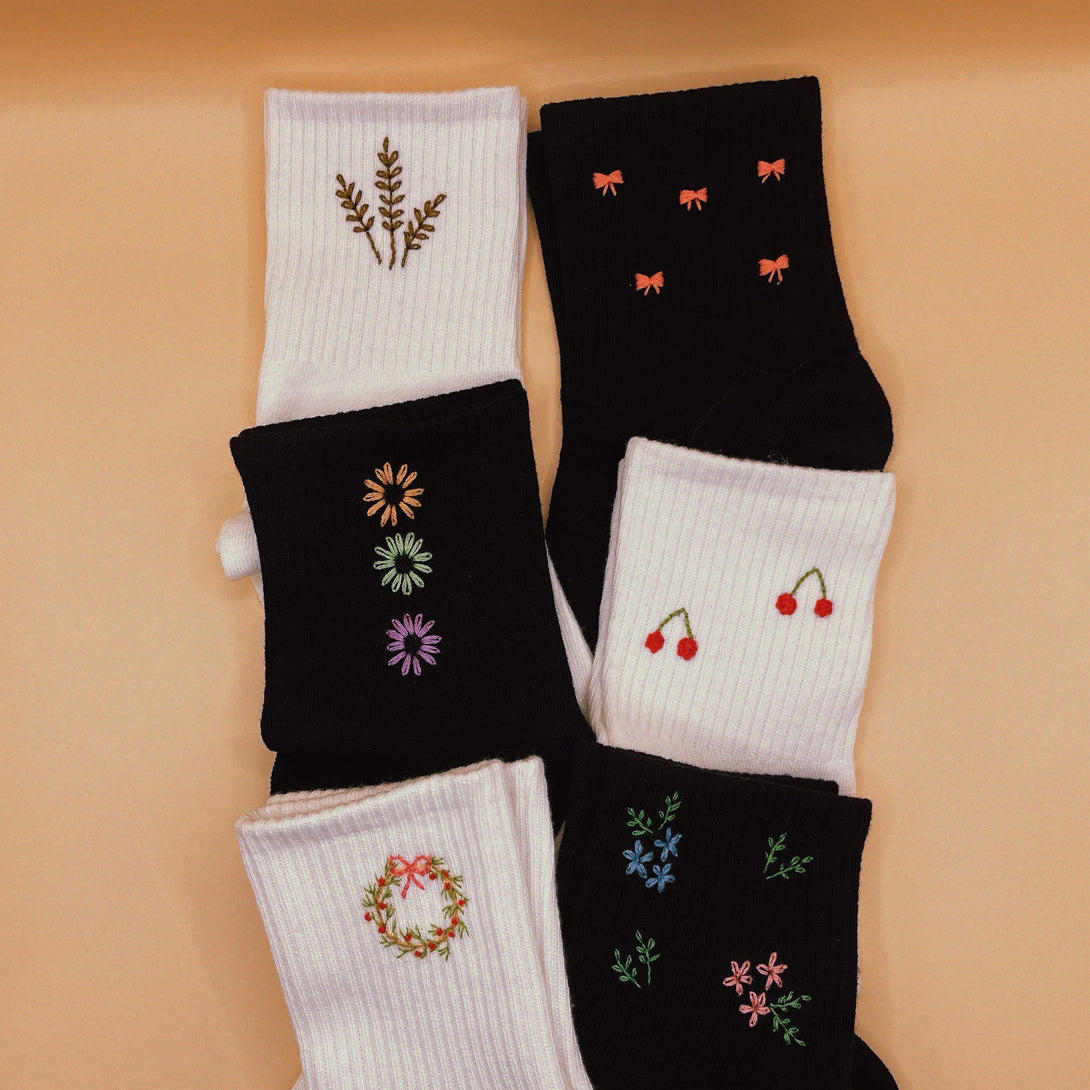 Set of Tennis Socks Embroidered For Women with floral and bow designs in black and white colors