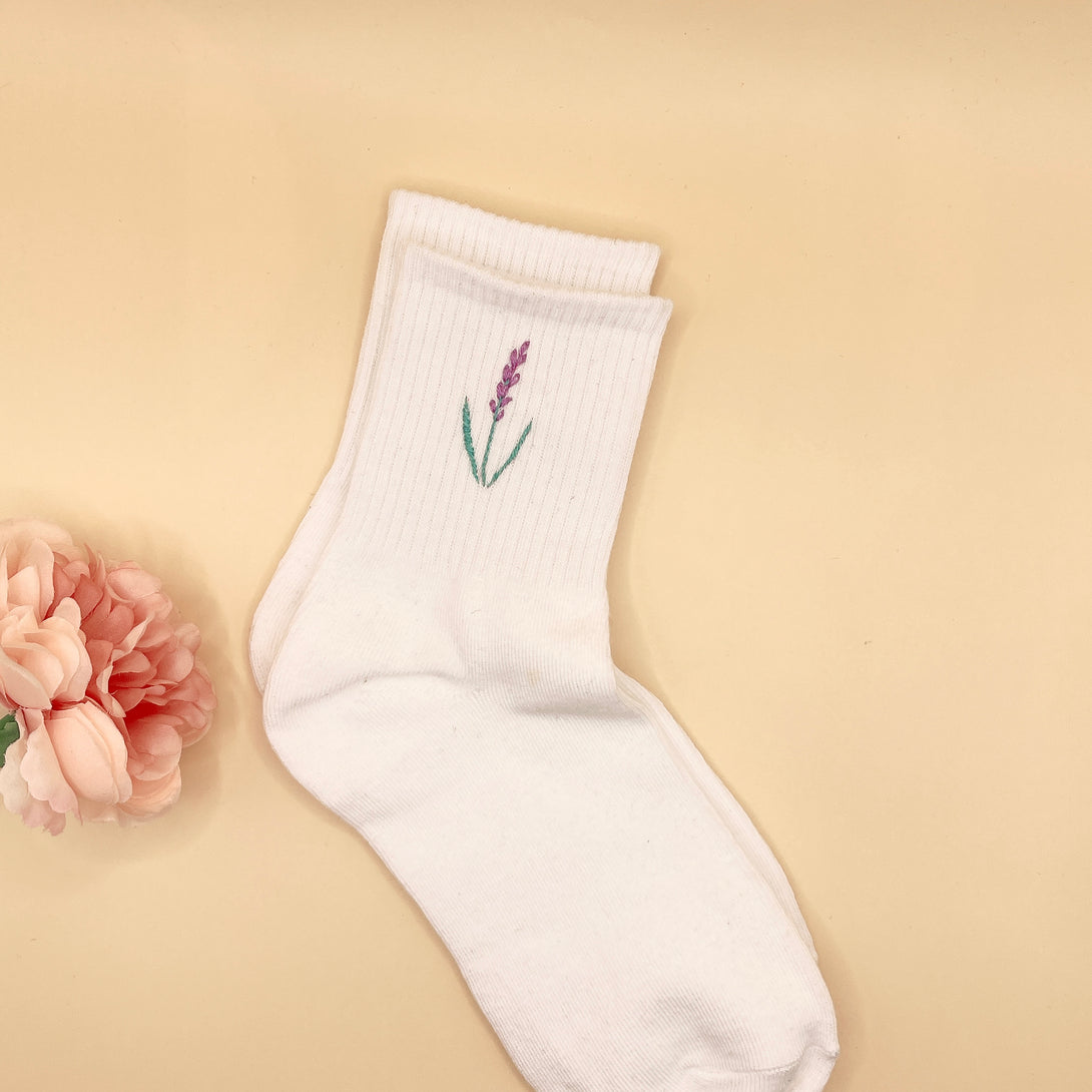 White Tennis Socks Embroidered For Women with purple flower design on beige background