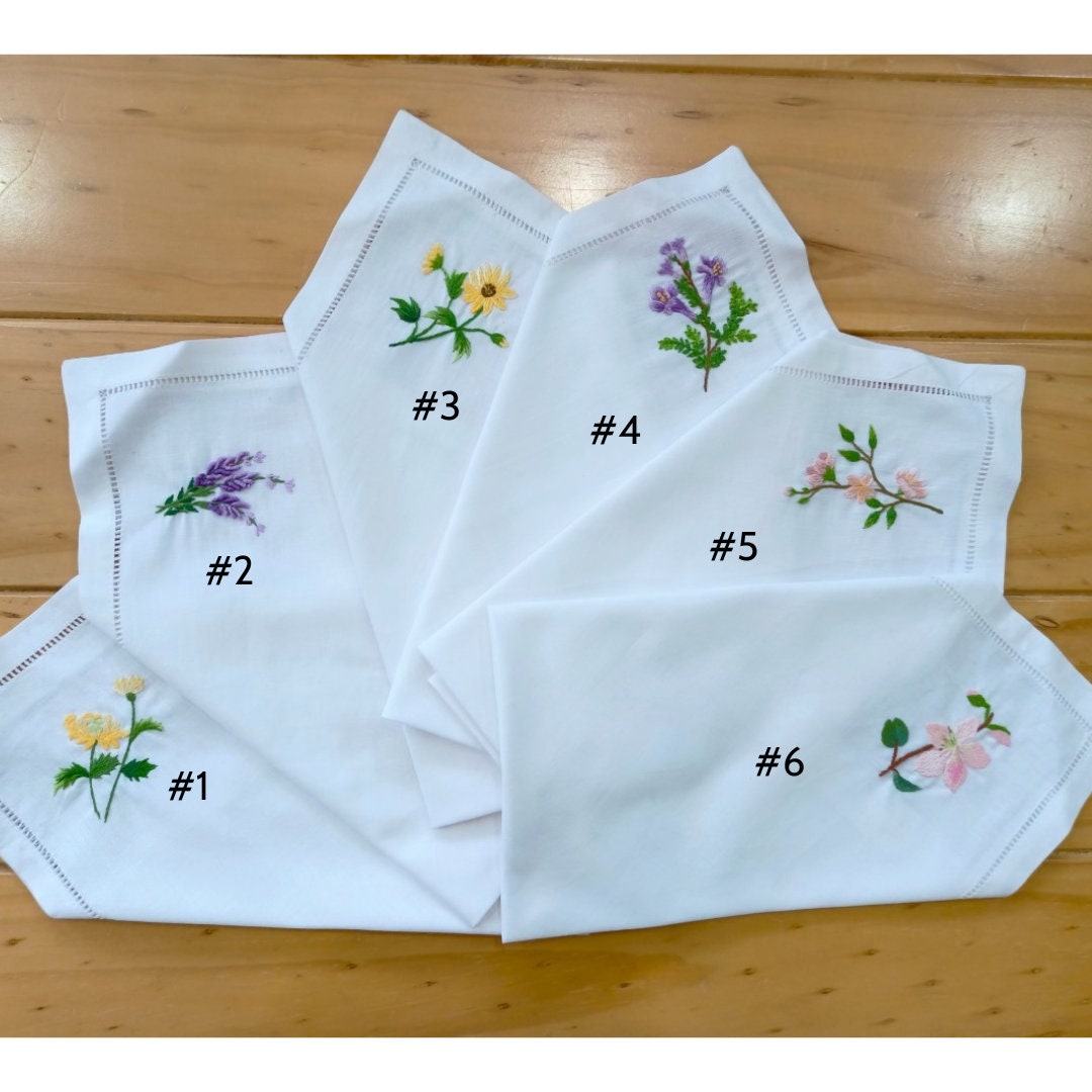 Stitchery Zone Wildflower Linen Dinner Napkins set with colorful embroidered floral designs on white linen